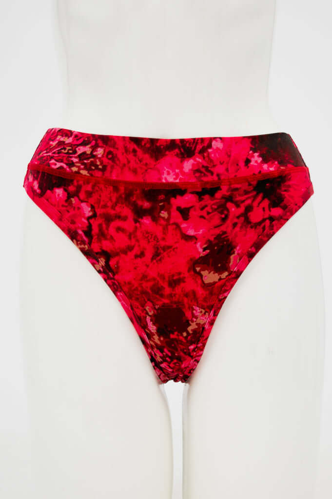 Front view of vibrant red patterned high-rise bamboo thong on mannequin