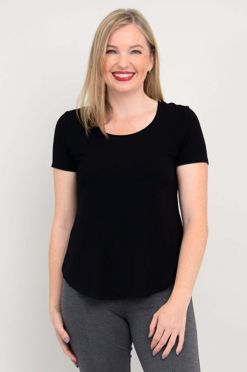 Front close-up of woman wearing a black scoop neck tee and grey pants