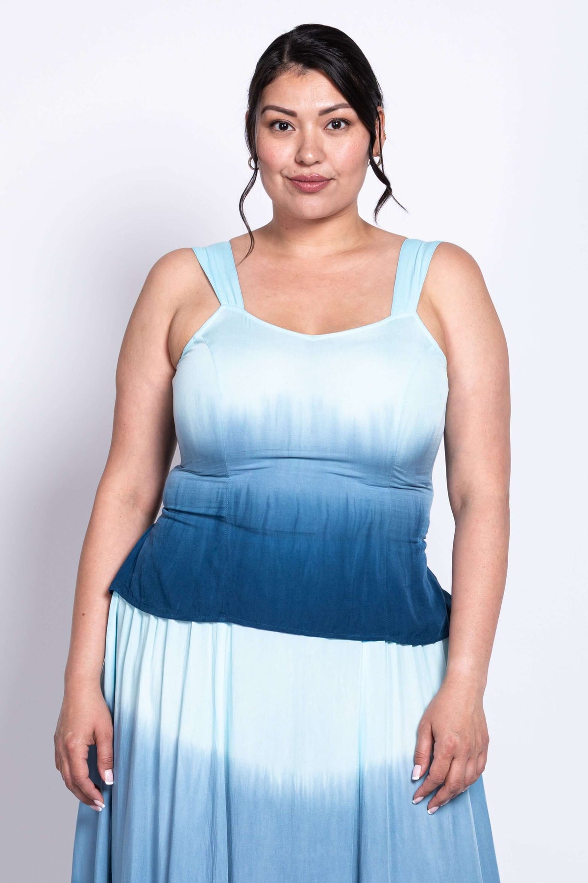 Front closeup of a woman wearing a blue ombre maxi dress