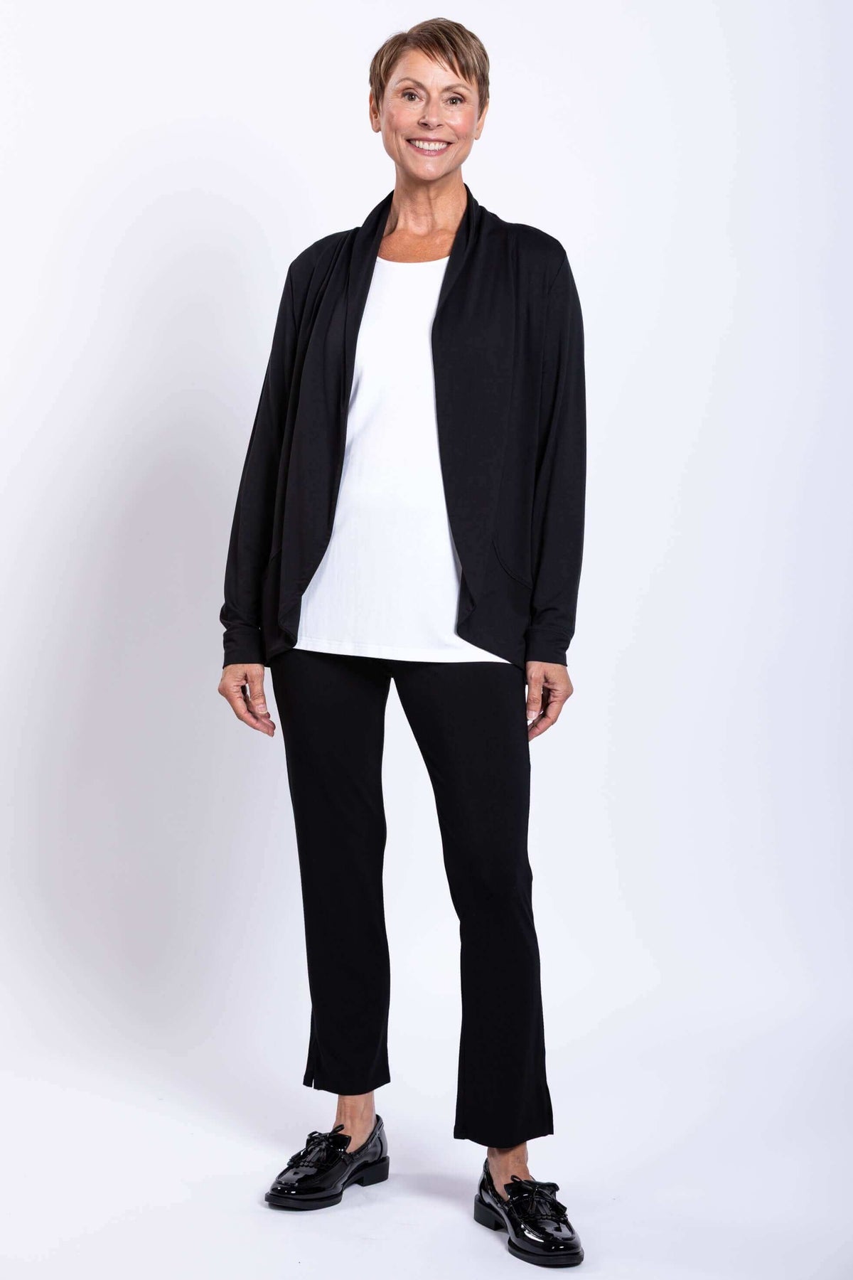 Front view of woman in black French Terry jacket with white shirt and black pants