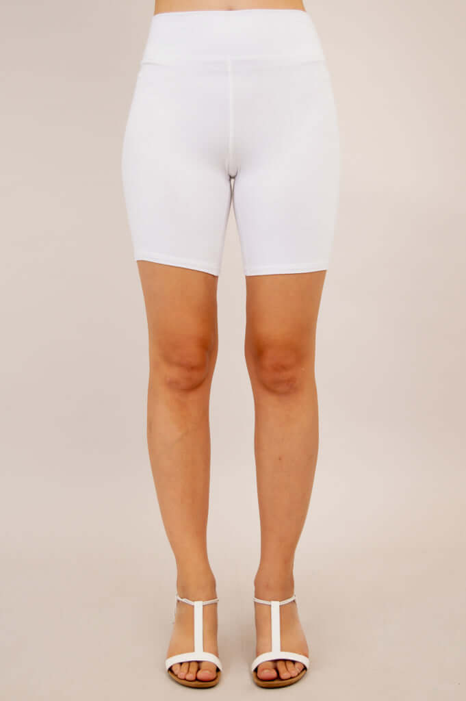 Front view of woman modeling white bamboo shorts with high waist