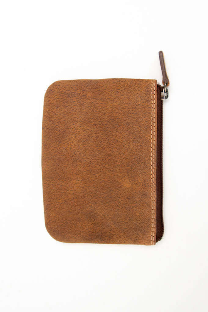 Front view of a compact brown leather zip wallet with visible stitching