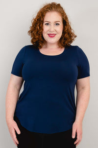Front view of model wearing a navy blue scoop neck short sleeve tee
