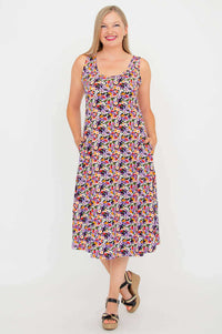 Front view of model wearing a floral sleeveless tank dress with pockets