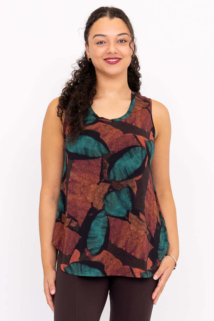 Front view of model wearing sleeveless top with autumn leaf print