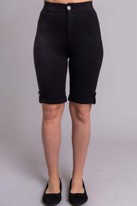 Front view of model wearing black Norma tailored shorts with cuffed hem