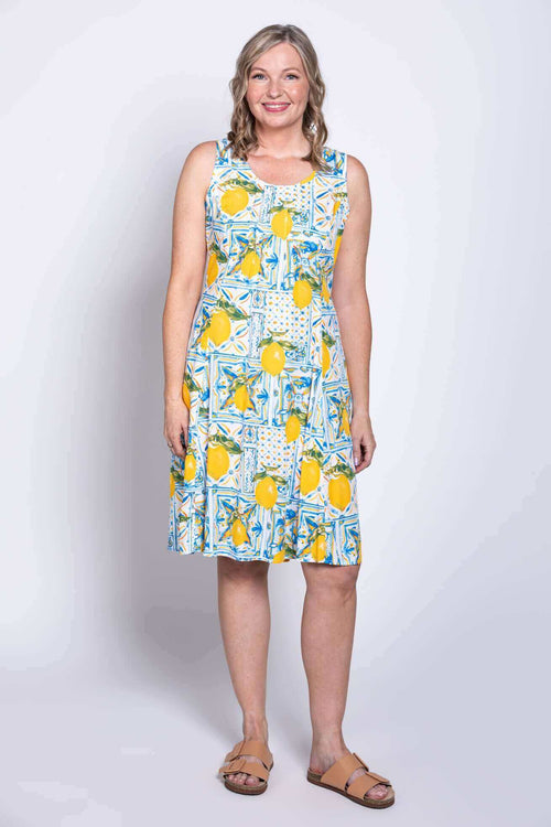 Front view of model wearing sleeveless lemon tile print dress with scoop neckline