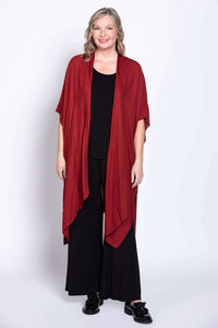 Front view of a woman wearing a crimson Darcy kimono wrap over black outfit