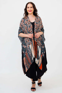 Front view of model wearing a colorful Darcy kimono wrap over a black outfit