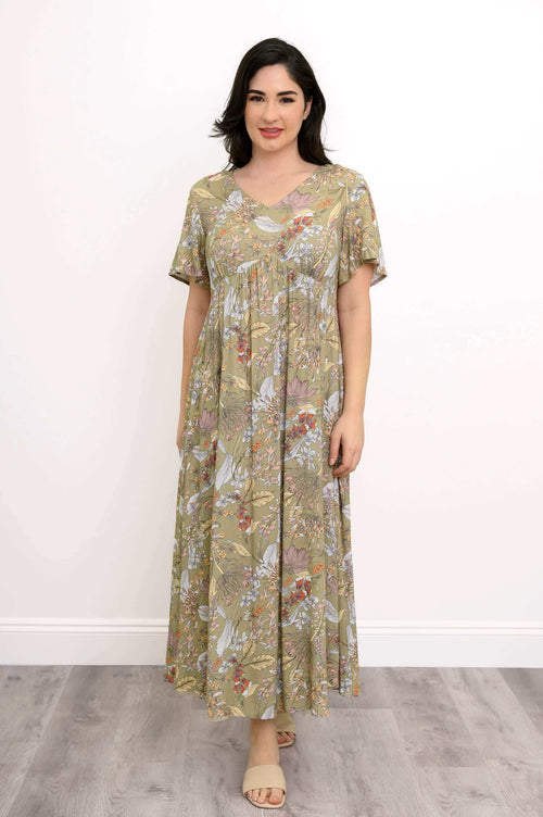 Front view of woman wearing green floral empire waist maxi dress