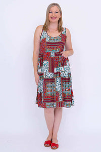 Front view of a woman wearing a colorful patchwork sleeveless summer dress
