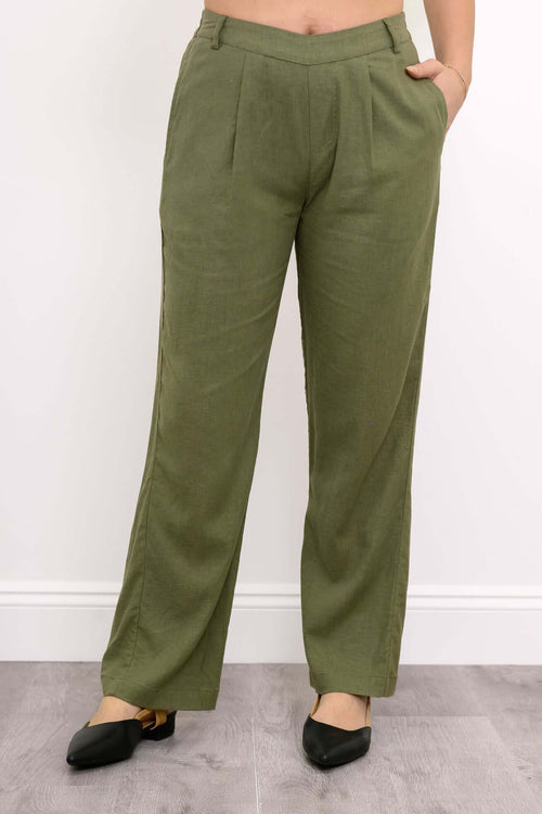 Front view of model wearing olive green linen blend pants with pleats and pockets