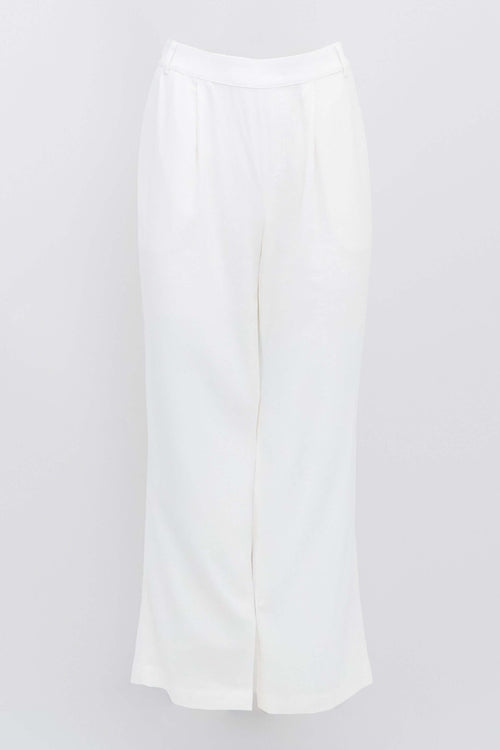 white pleated wide-leg trousers against a white background
