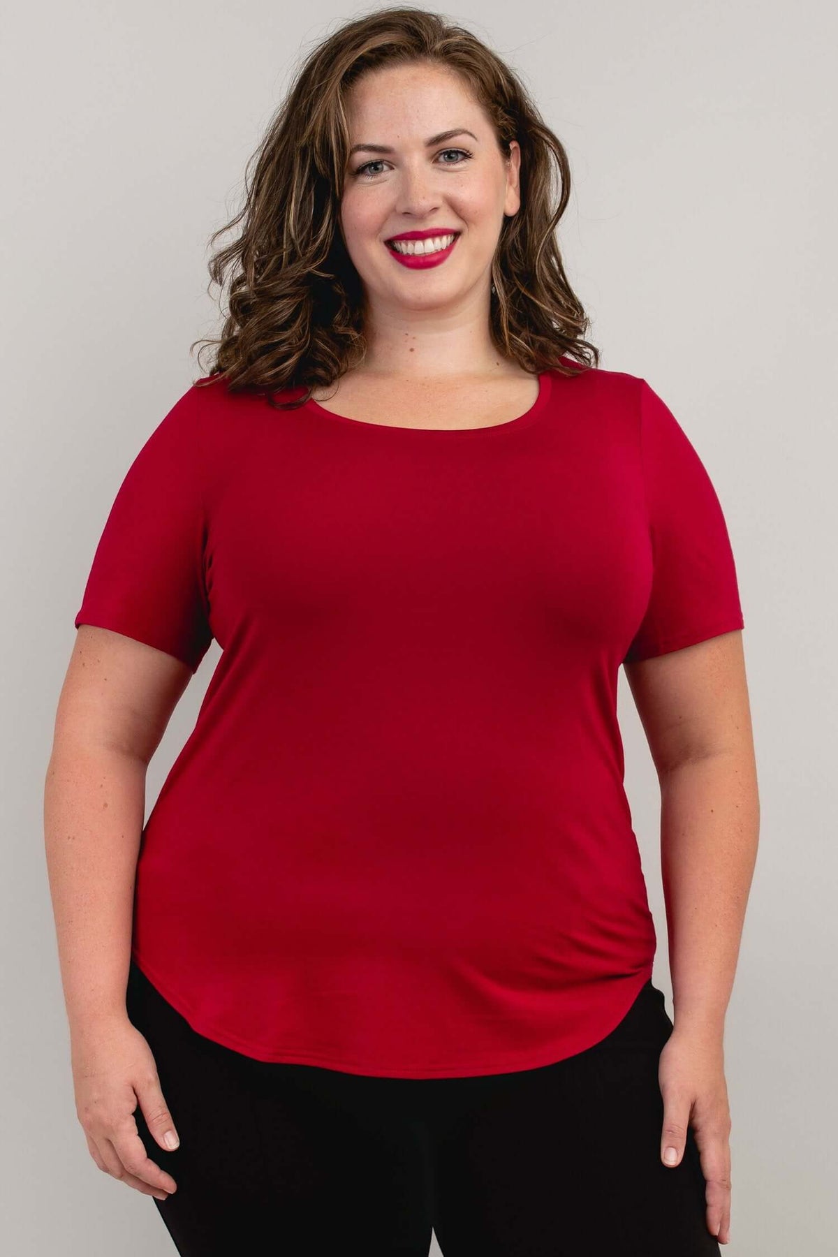 Woman wearing a crimson scoop neck short sleeve tee, front view