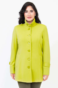 Front view of woman wearing lime green long button-up jacket
