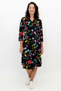 Front view of a woman wearing a black floral wrap dress with three-quarter sleeves