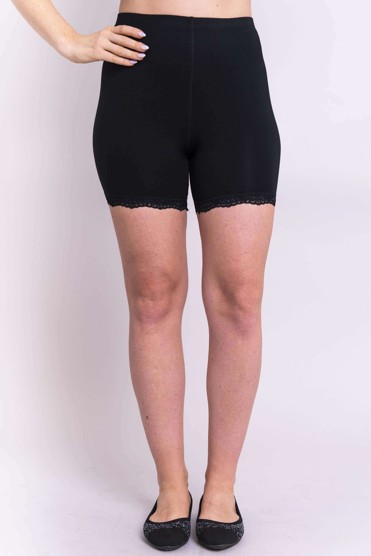 Front view of a woman wearing black bamboo undershorts with lace trim