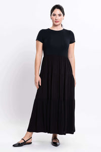Front view of woman wearing a black maxi dress with short sleeves