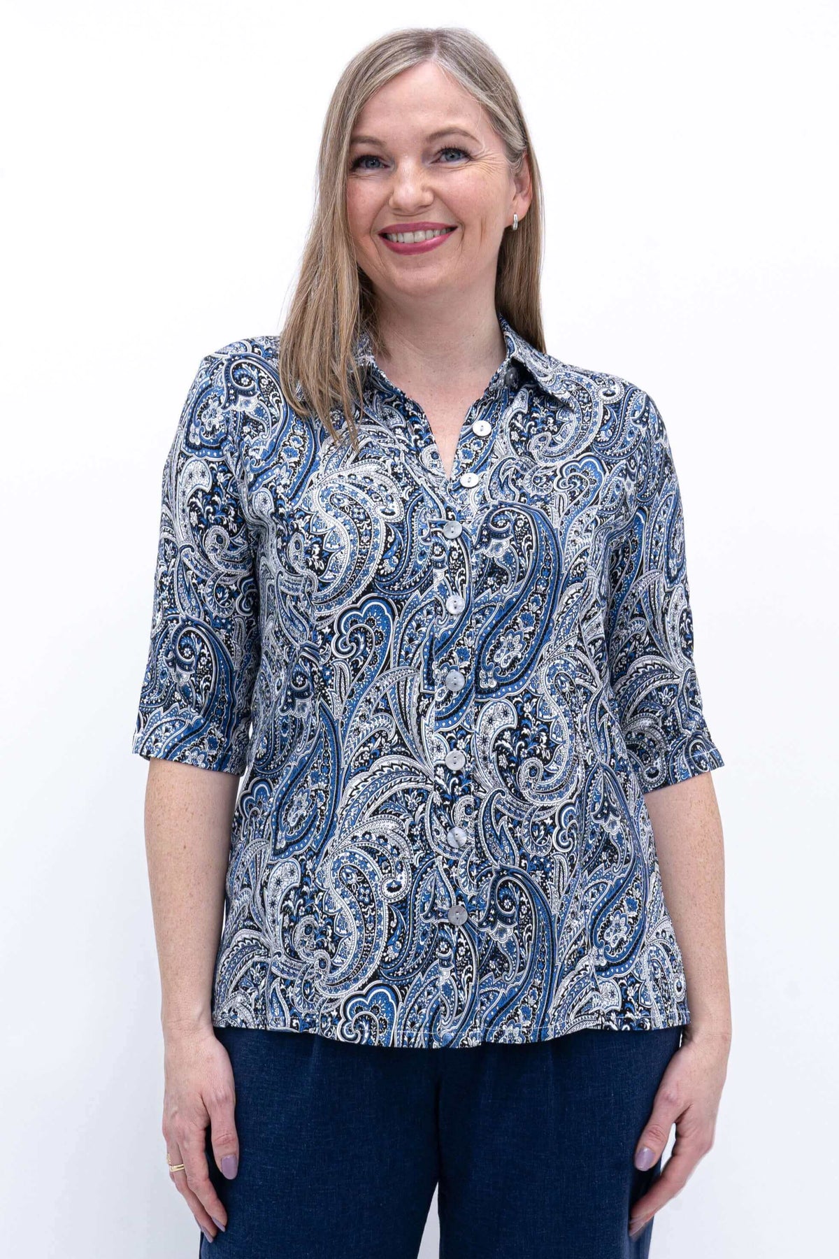 Front view of woman wearing blue paisley bamboo and linen blouse with collar and elbow-length sleeves