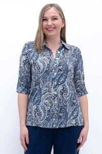 Front view of woman wearing blue paisley bamboo and linen blouse with collar and elbow-length sleeves