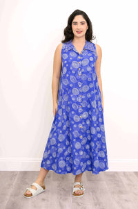 Front view of model wearing a sleeveless blue A-line dress with white circle patterns
