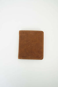 Front view of a brown leather bifold wallet on white background