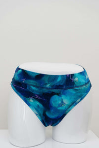 Front view of high rise blue watercolor bamboo thong on a mannequin