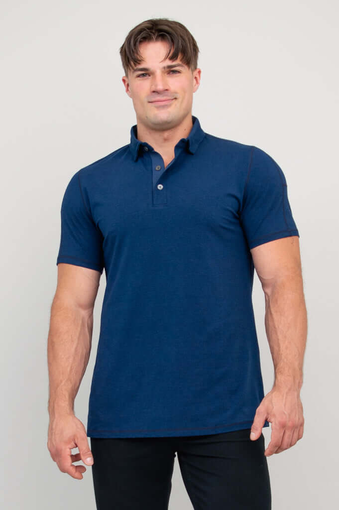 Man wearing a navy bamboo polo shirt, front view, against plain background