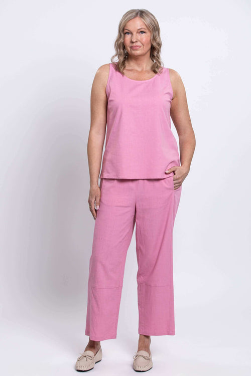 Model wearing pink cropped linen-blend pants and matching sleeveless top, front view