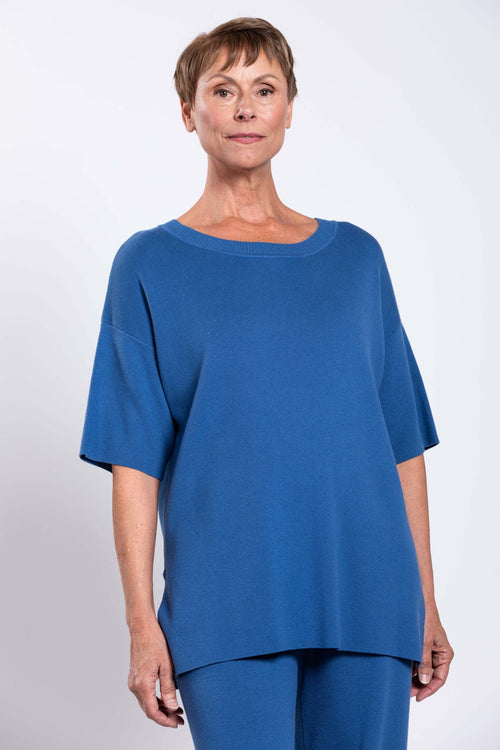 Front view of model wearing blue Sweater with short sleeves