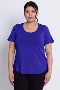 Front view of a woman wearing a purple scoop neck short sleeve tee