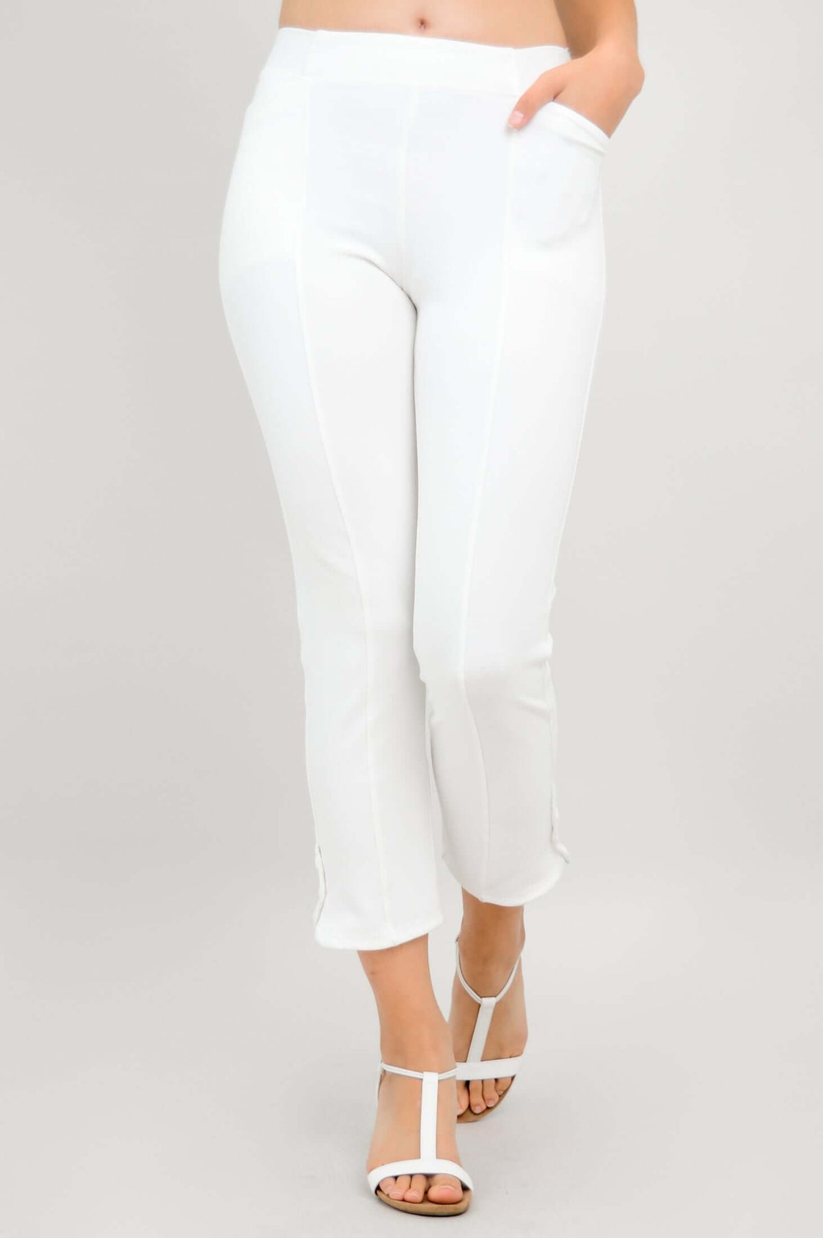 Front view of white Nadine crop pants with hand in pocket
