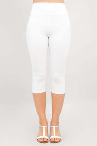 Front view of model wearing white capri leggings and white sandals