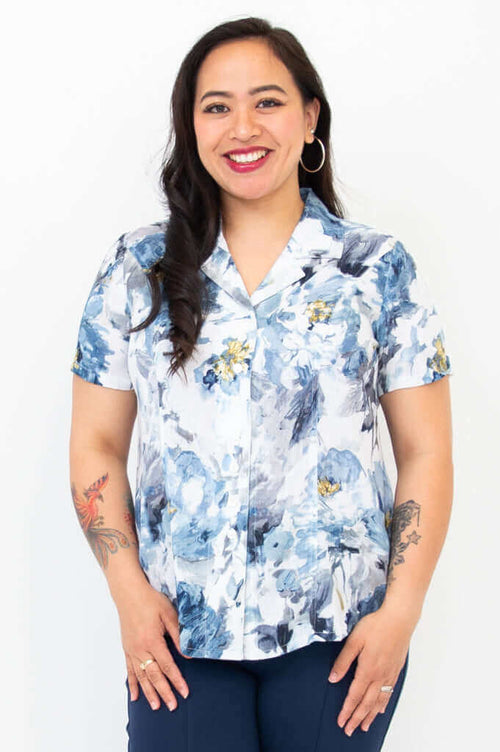 Front view of woman wearing blue and white floral linen bamboo shirt with short sleeves
