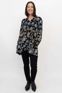 Full-length front view of woman in Stanley Blouse with circle design and black pants