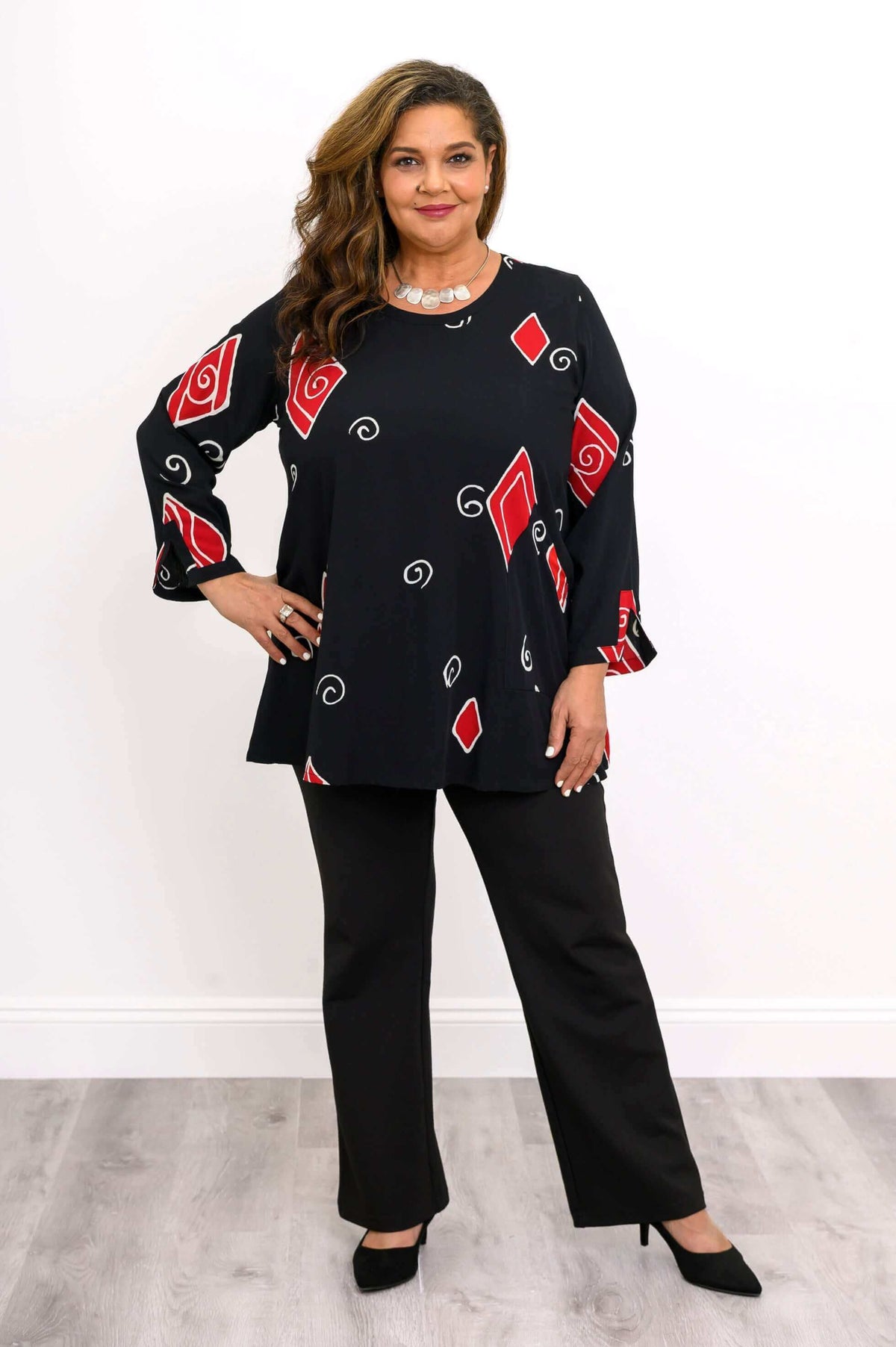 Full-length view of the Palace Blouse styled with black pants and heels