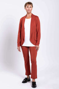 Full body view of woman in rust French Terry jacket and matching pants