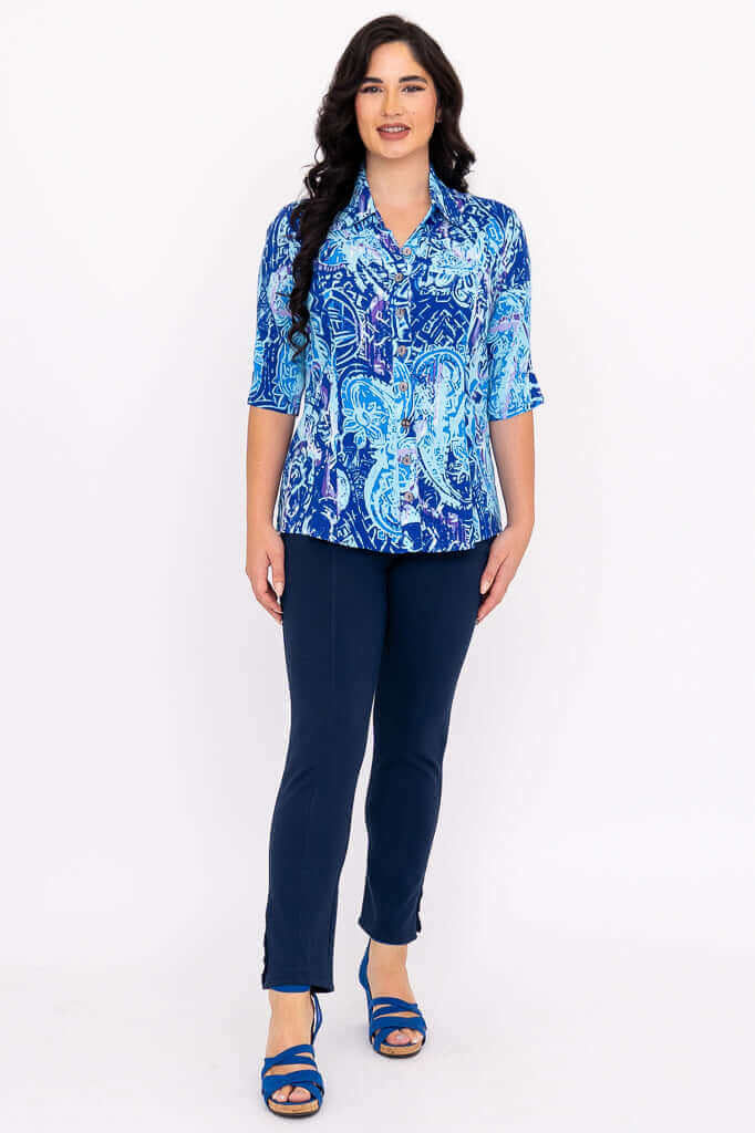 Full front view of model in blue print blouse and navy pants with blue sandals