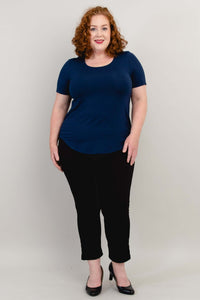Full front pose of model wearing navy blue tee with black pants