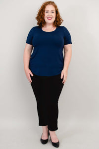 Full front view of model in navy blue tee and black pants