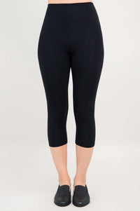 Full front view of black capri leggings on model standing straight