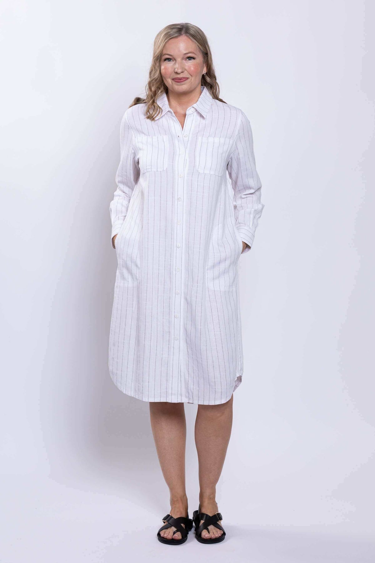 Full front view of a model in white striped button-down duster dress