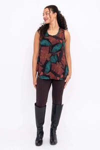 Full body front view of model in round-neck sleeveless tank and brown pants with boots
