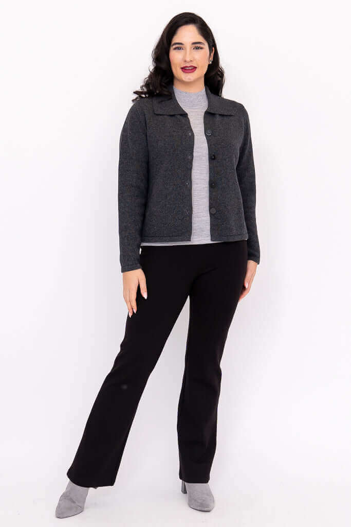 Full-length view of model in a charcoal gray buttoned cardigan paired with black pants and gray shoes