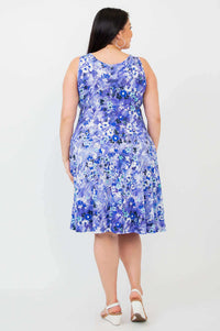 Back view of model wearing Genesis blue floral dress