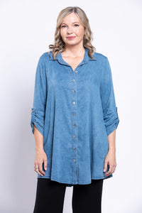 Woman wearing tencel denim tunic with gathered sleeves and flared hem