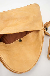 Interior view of tan leather crossbody bag with magnetic closure