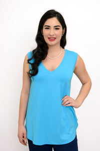 Close-up of a model wearing a turquoise sleeveless V-neck tank top with a relaxed silhouette