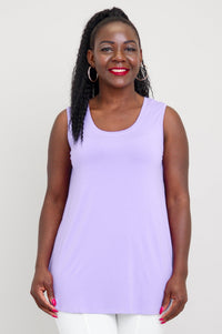 A woman wearing a sleeveless lavender tank top with a round neckline and a longer hemline.