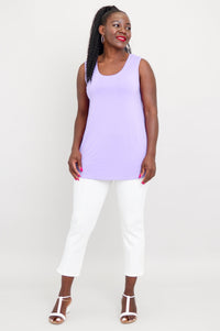 woman modelling a loose-fit light purple sleeveless bamboo top and slim fit white pants